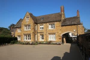 The historic Hornton stone frontage of Featherton House senior living home near Banbury.