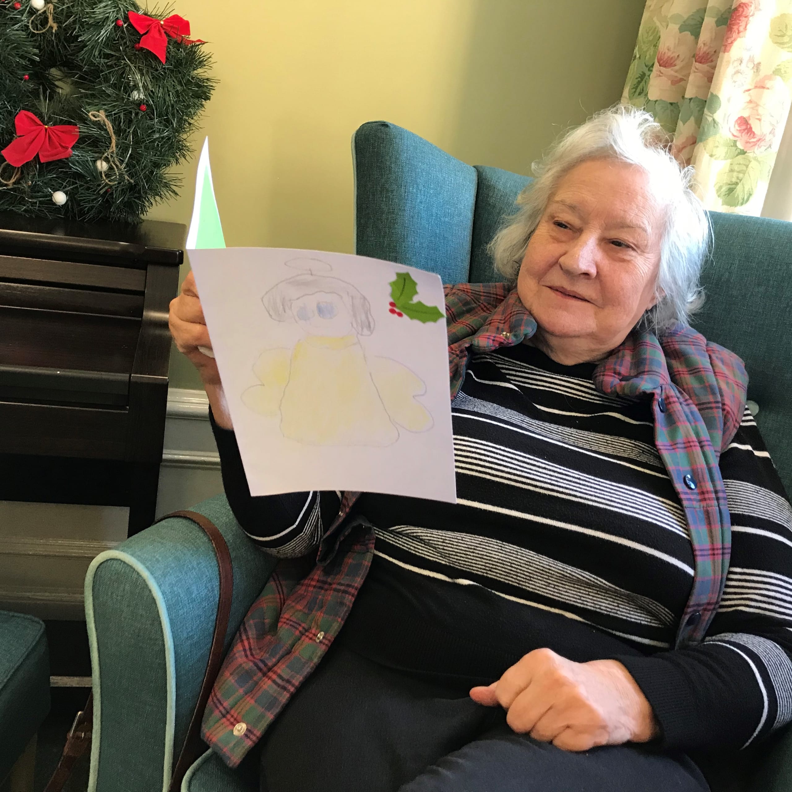 Featherton House Care Home resident Jean Waddup with her handmade Christmas card from local school children.