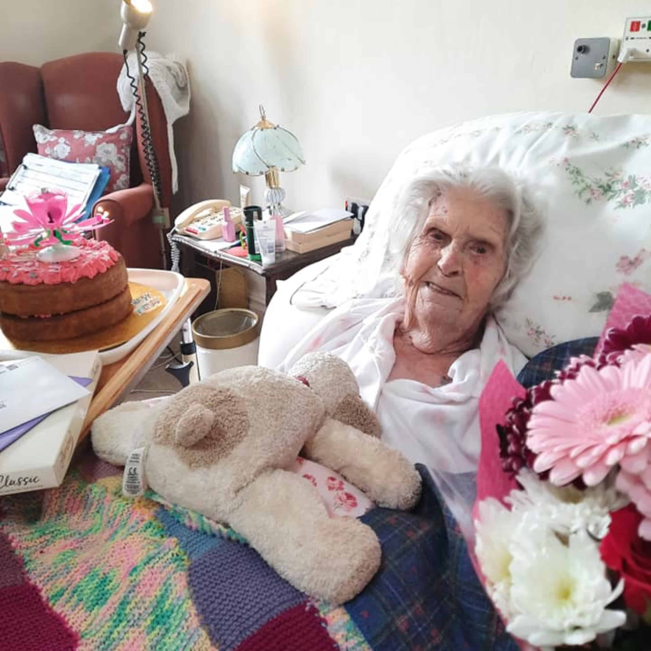 Wren House Care Home resident Barbara Elliot with her birthday cake and flowers.