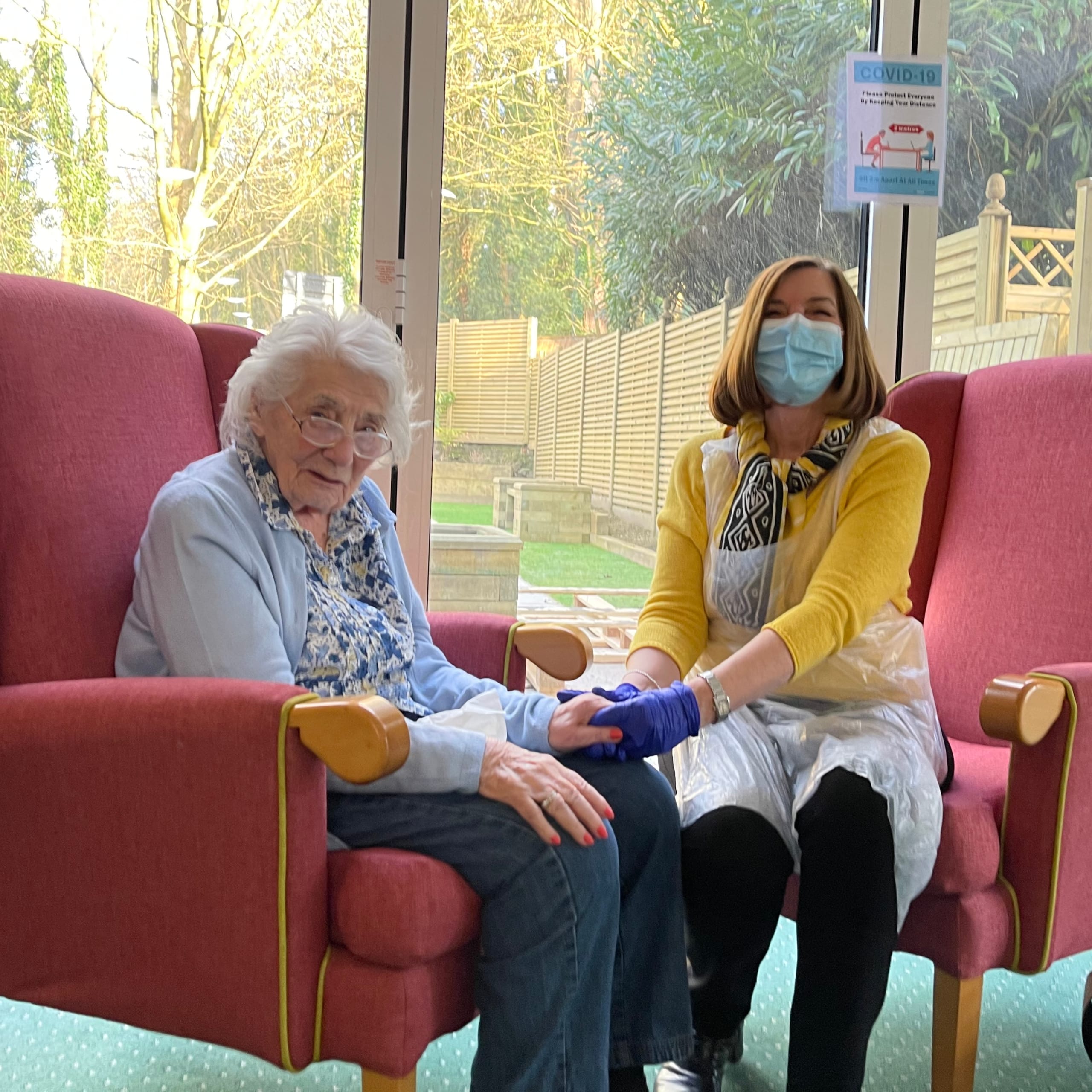 Westerham Place Care Home resident Joan welcomes her daughter in the designated visiting room for the first time.